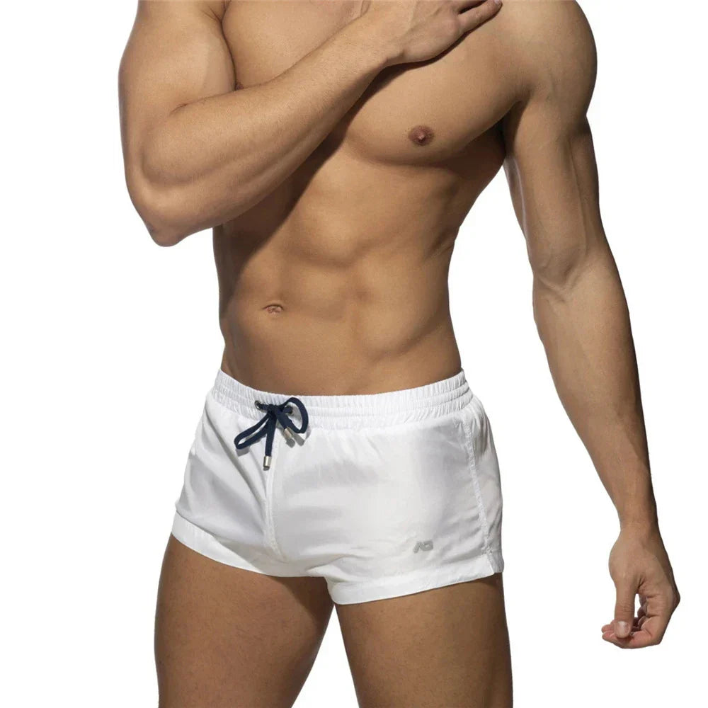 New Mens Swimming Trunks Classic Solid Color Three Point Quick Drying Swimming Trunks Low Waist Sexy Beach Surfing Sports Shorts